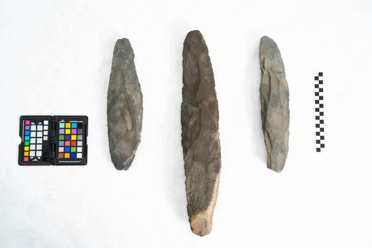 Three Acheulean hand axe artifacts from AlUla with color checker and scale