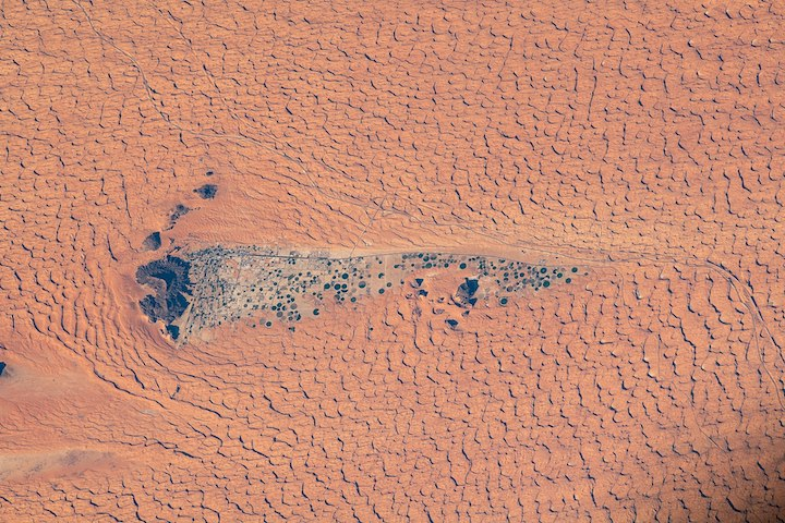 Satellite view of Jubbah city surrounded by Nefud sand dunes with center-pivot fields