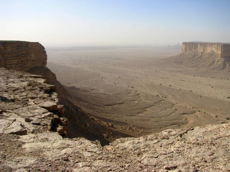 Layered escarpments and arid valley floor of the western Nefud Desert on the Nejd Plateau